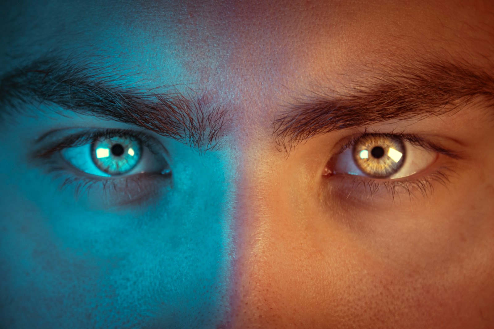 a man's face with two different colored eyes